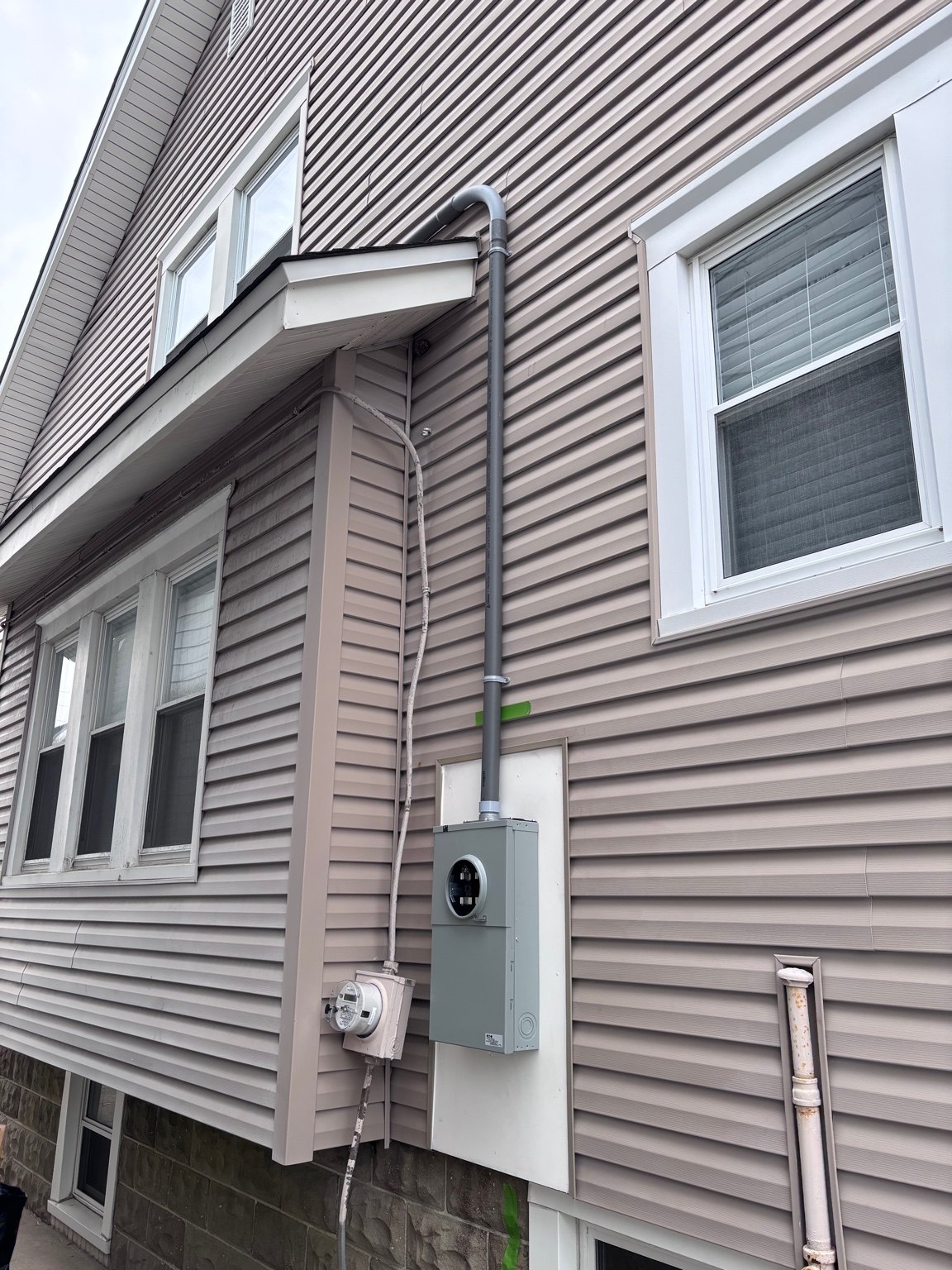 Exterior electrical service equipment on a residential building